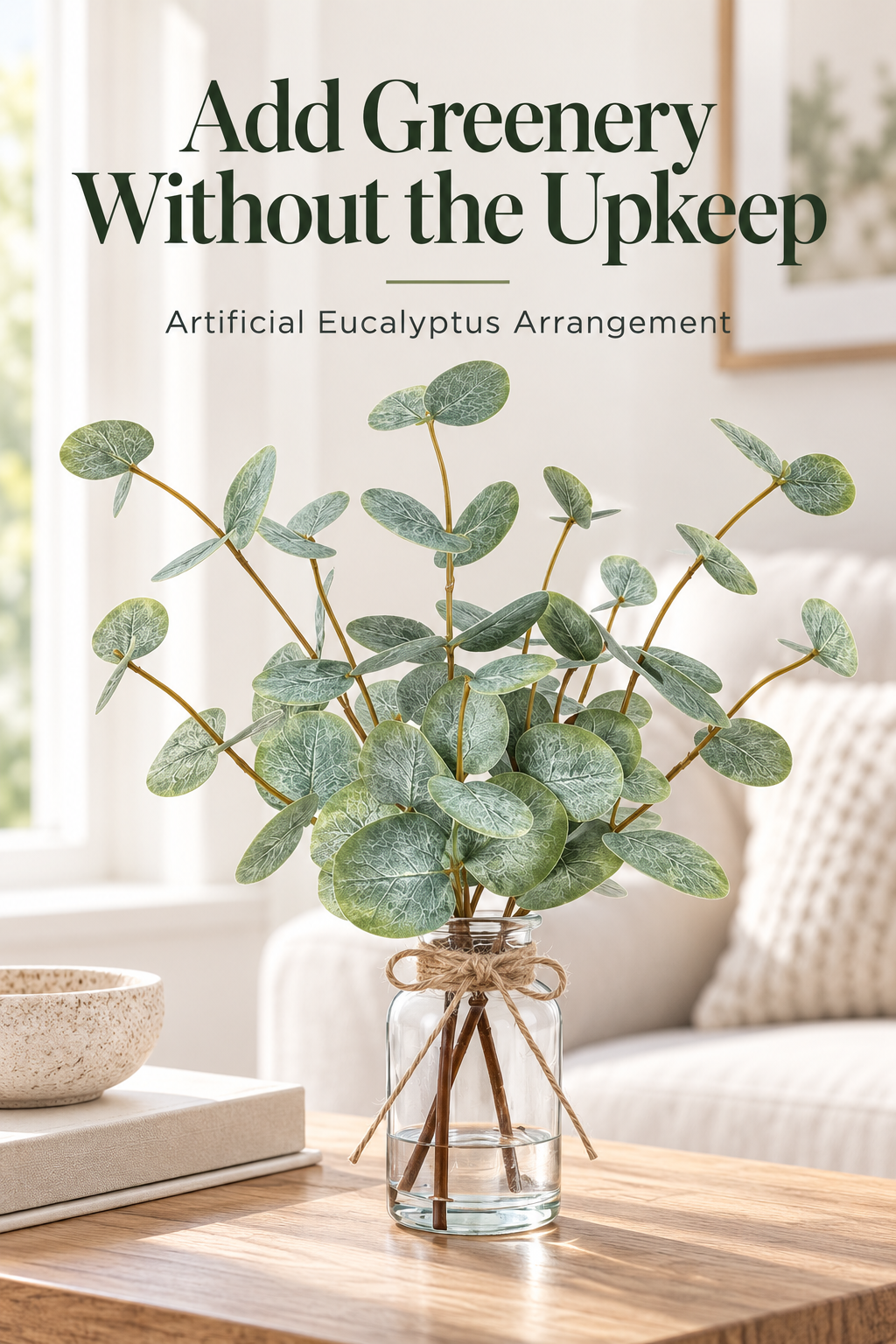 Artificial eucalyptus arrangement in a glass vase on a warm coffee table with the headline Add Greenery Without the Upkeep.
