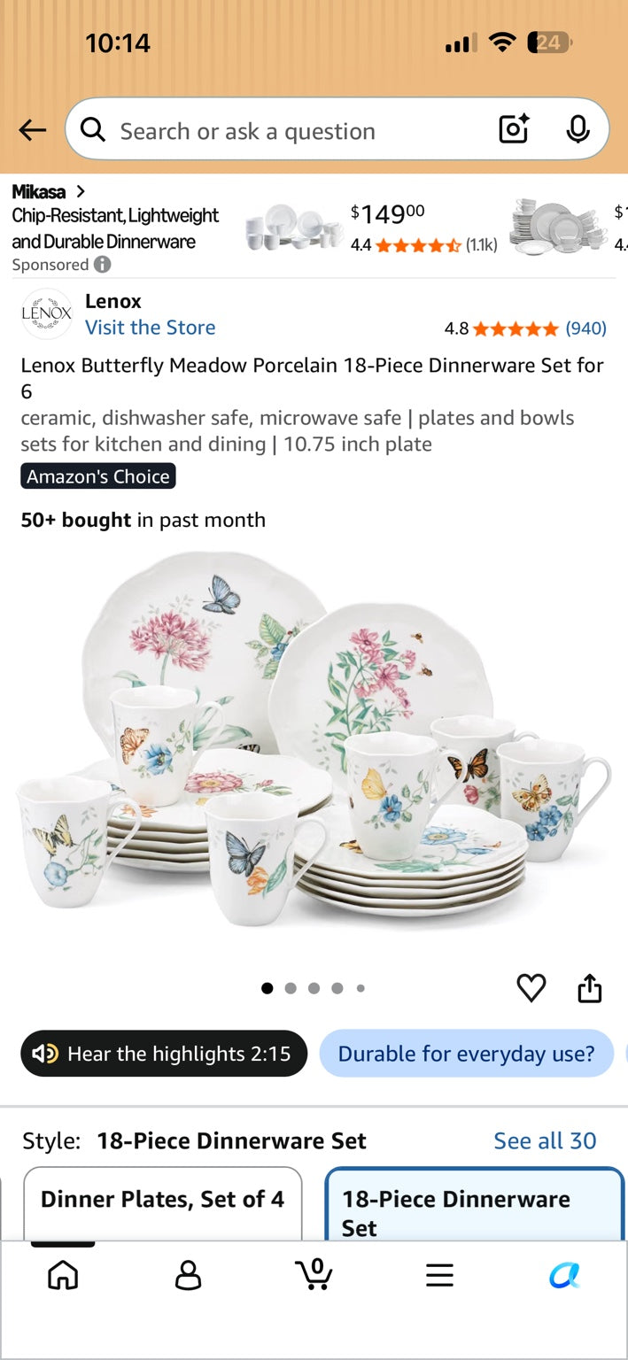White floral and butterfly dinnerware set with plates and mugs arranged together.