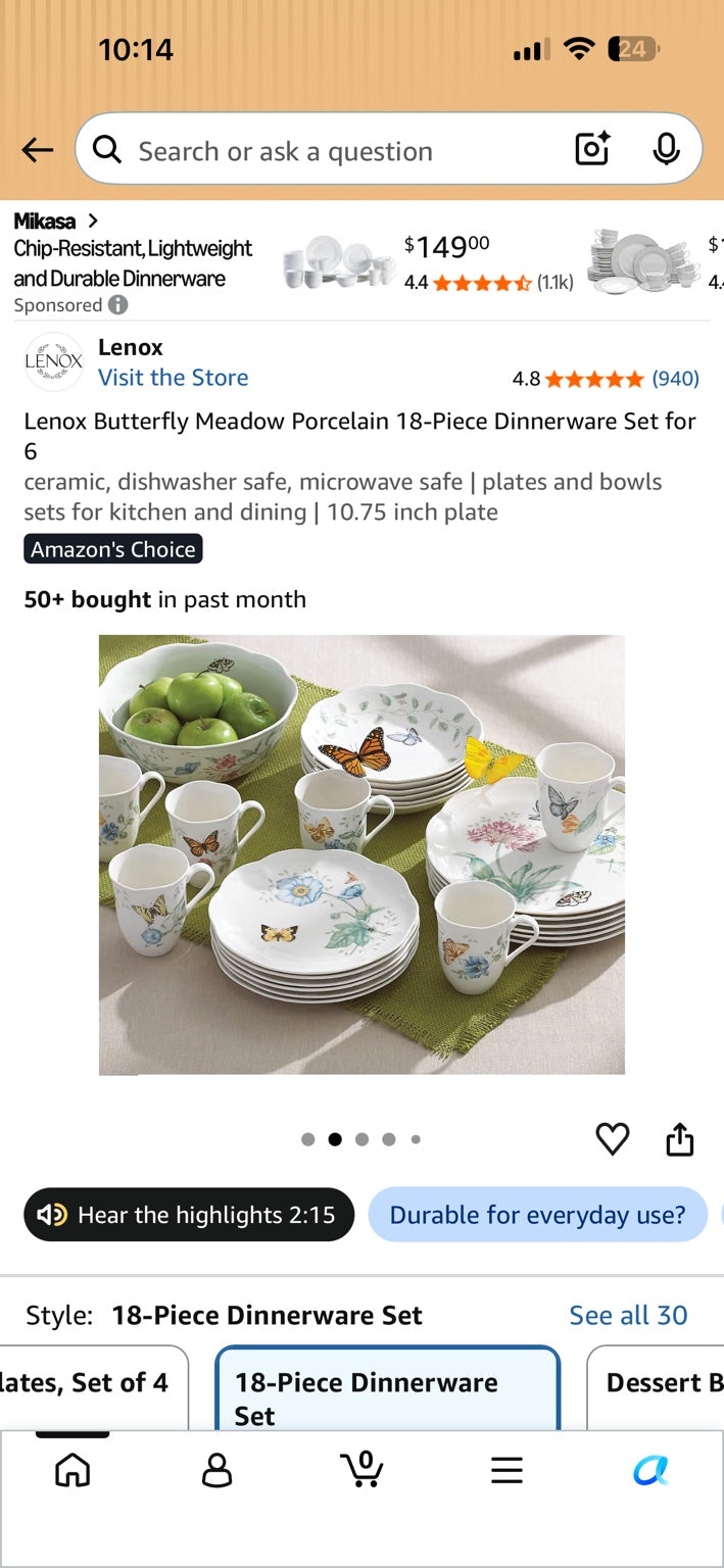 Floral and butterfly dinnerware arranged on a dining table with plates, mugs and a serving bowl.