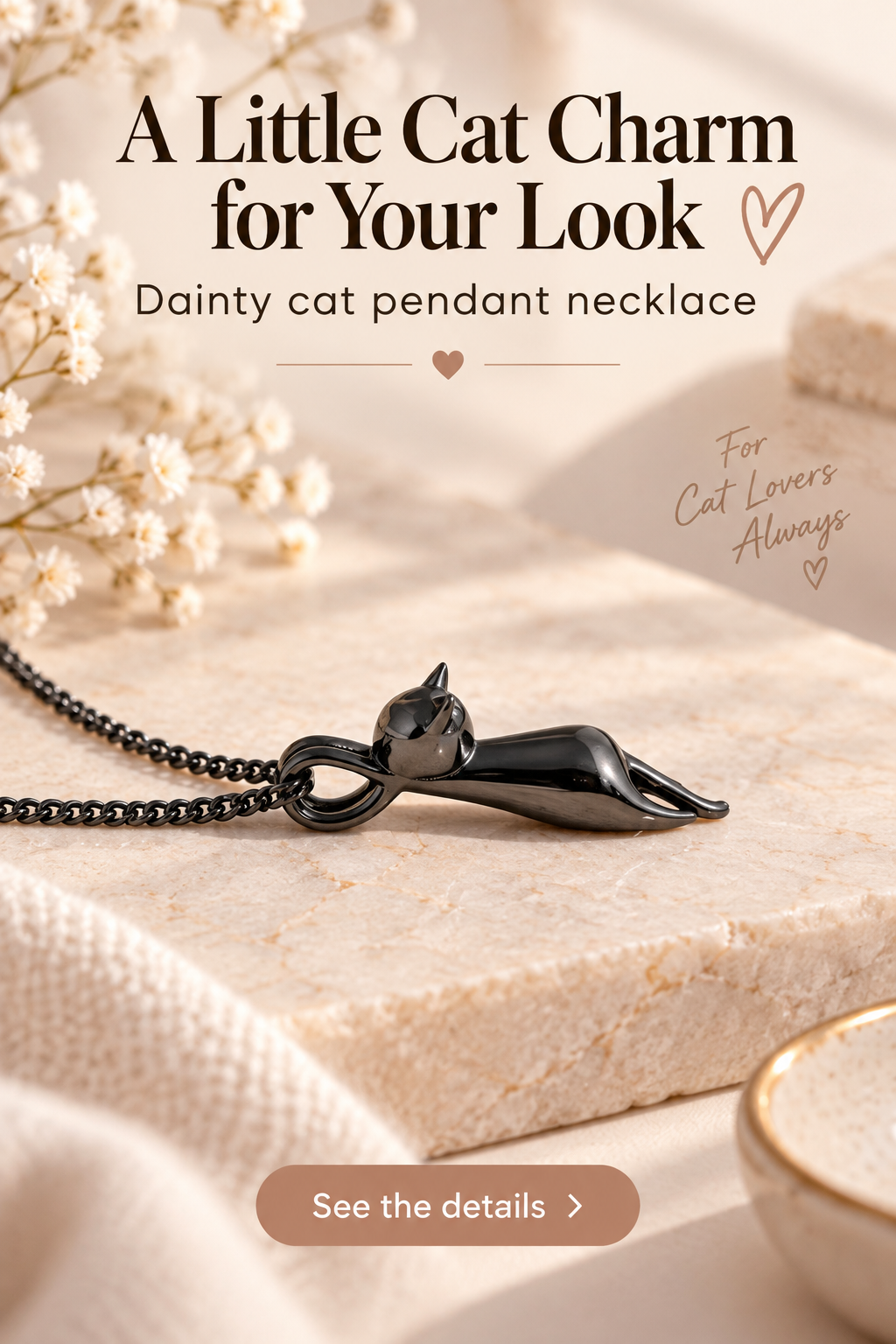Gunmetal cat pendant necklace on cream marble with headline A Little Cat Charm for Your Look.
