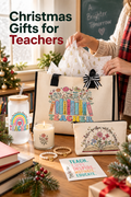 Vertical holiday classroom scene showing a woman’s hands opening a cream teacher tote with black handles, striped bow, colorful books and flowers, and festive tissue paper. On the desk are a teacher-themed lidded tumbler with straw, candle, floral zip pouch, two beaded bracelets, appreciation card, books, greenery and a wrapped gift. A Christmas tree and chalkboard sit in the background. Large headline at upper left reads “Christmas Gifts for Teachers.”