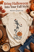 Cream Halloween graphic tee with dancing skeleton and pumpkin in a warm fall flat lay, with the headline Bring Halloween Into Your Fall Style.