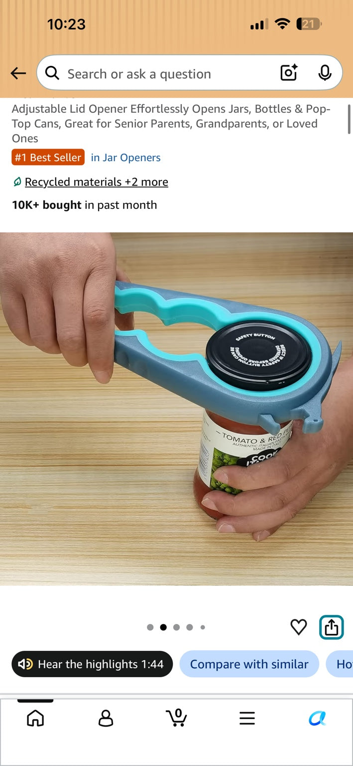 Hands using the blue and grey adjustable opener on a jar lid.