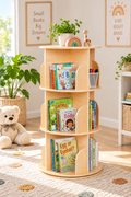 Three-tier rotating kids bookshelf filled with colorful books in a bright nursery reading nook