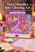 Vertical Pinterest image showing a white LED drawing board glowing on a warm craft desk in a cozy bedroom. The board displays neon-style art of a unicorn, bunny, rainbow, stars and flowers, with colorful markers and tracing sheets in front. A plush bunny, lamp, plants and soft decor appear in the background. Headline text reads “Turn Doodles Into Glowing Art,” with supporting text “Reusable LED drawing board for creative play” and “Trace • Draw • Display.”