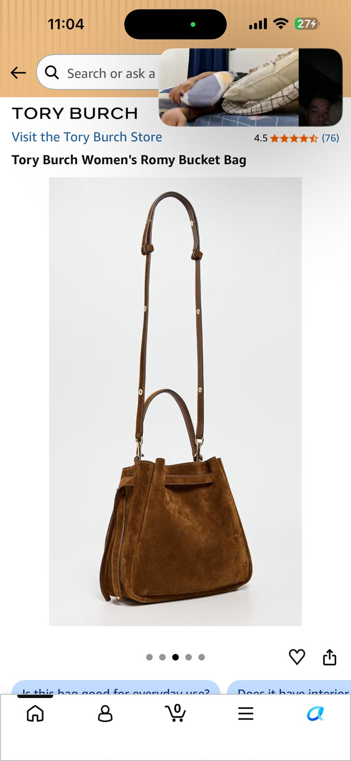Caramel suede bucket bag with top handle and adjustable shoulder strap.