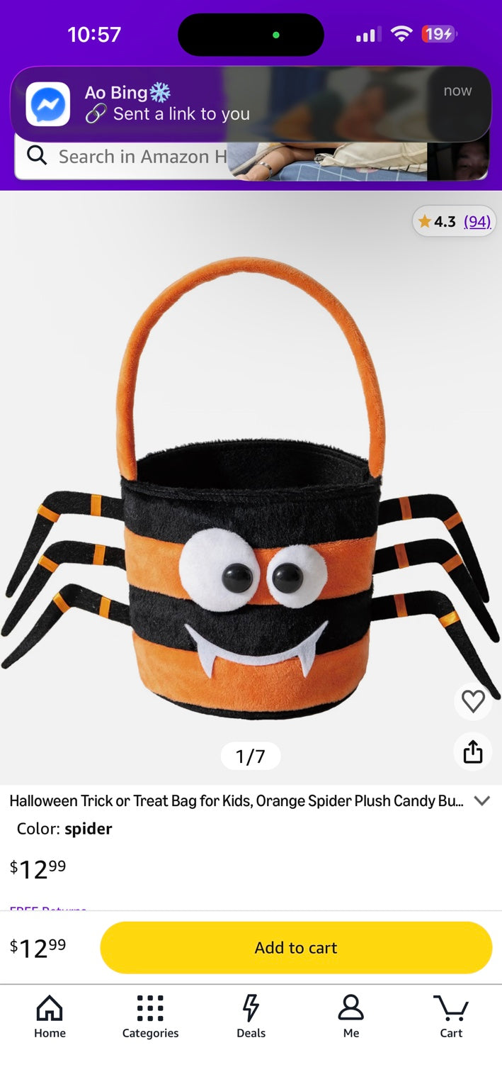 Black-and-orange plush spider trick-or-treat candy bucket with orange handle and eight legs.