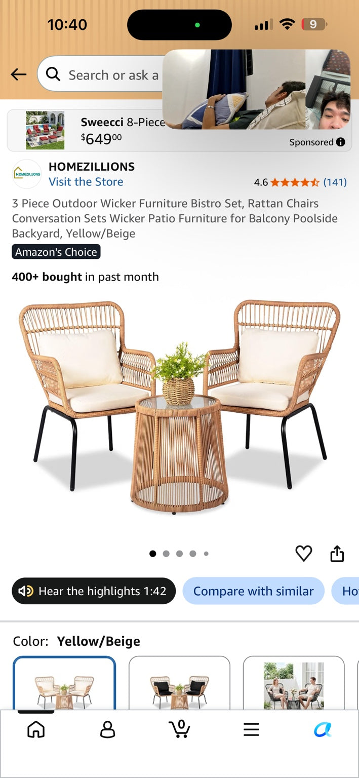 Three-piece natural wicker patio bistro set with two beige-cushioned chairs and a round glass-top table.